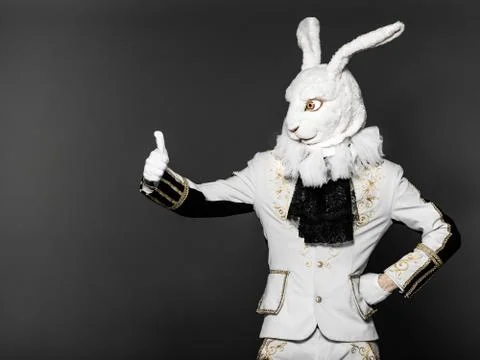 Actor posing in white rabbit suit on black background.Studio shot.Halloween time Stock Photos