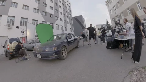 Actor pushes vehicle while driver attempts to start engine Stock Footage 306552604