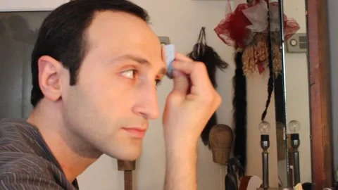 The actor is putting on himself makeup 10 Stock Footage 322072249