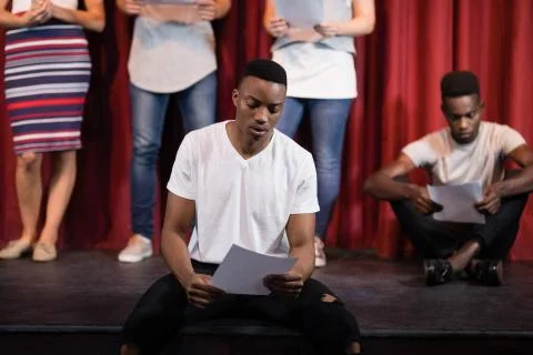 Actor reading his scripts on stage Stock Photos
