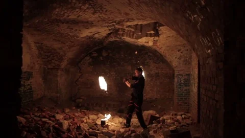 An actor shows fire show in the old German fort. Stock Footage 79681144