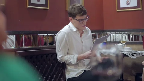 The actor, sitting in front of the audience in a cozy interior, reads prose from Stock Footage 103169042