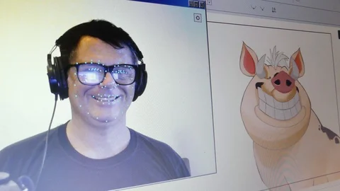 An actor uses motion capture to animate expressions on a character Stock Footage 112140611