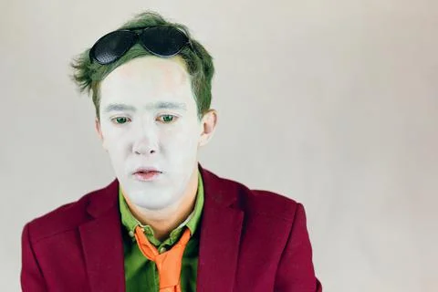 Actor with white makeup on face and green eyes and hair. Stock Photos