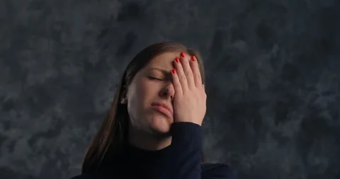 Actor woman does facepalm move in studio on the dark background, 4k 60p Prores Stock Footage 168568879