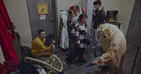Actors Backstage: Preparing for a Theatre Performance with Costumes, Wigs, and Stock Footage 312066113