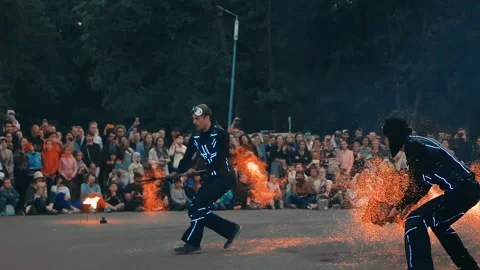 Actors of the fire show perform a trick with hot coals, sparks fly in the wind. Stock Footage 160759453