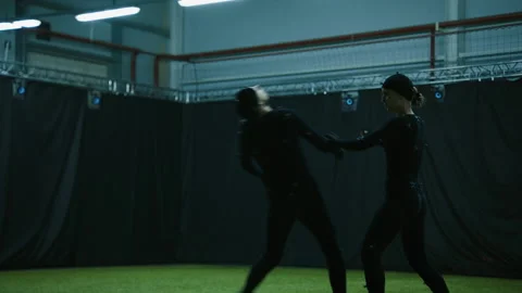Actors in motion capture suits performing some fight moves as a game characters Stock Footage 166023196