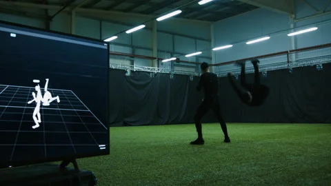 Actors in motion capture suits performing some fight moves as a game characters Stock Footage 166023236