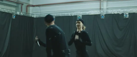 Actors in motion capture suits performing some fight moves as game characters Stock Footage 166099059