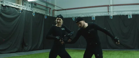 Actors in motion capture suits performing some fight moves as game characters Stock Footage 166139499