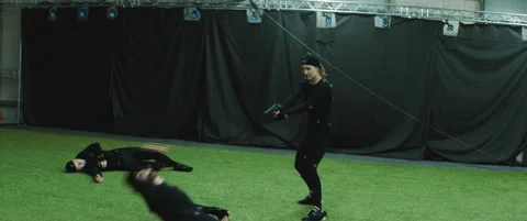 Actors in motion capture suits performing some fight moves as game characters Stock Footage 166139583