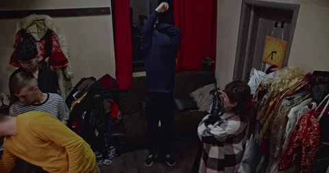 Actors Prepare Backstage: Costumes, Conversation, and Anticipation Before a Stock Footage 312062970