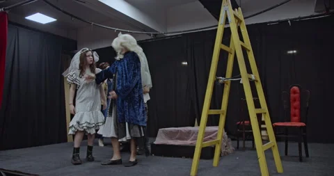 Actors Rehearse on a Theater Stage, Practicing Lines and Movements in Costumes Stock Footage 312063724
