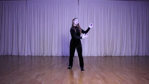 An actress juggles circus balls on stage. Stock Footage 309853719