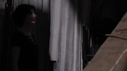 Actress performs in dark room with light ray slow motion Stock Footage 115258083