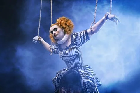 The actress plays a doll on strings at a performance in a puppet theater. A p Stock Photos