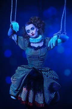 The actress plays a doll on strings at a performance in a puppet theater. A p Stock Photos