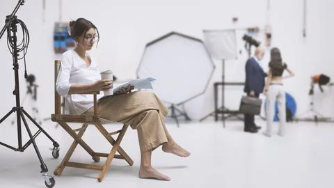 Actress reading the script in the film studio Stock Photos