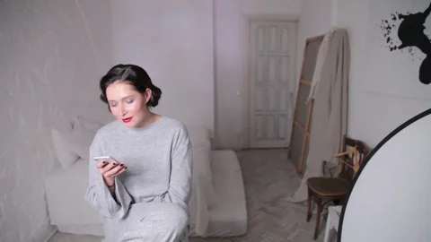 Actress with smartphone in workshop Stock Footage 83180441