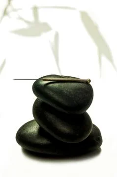 Acupuncture needle on stone Stock Photos