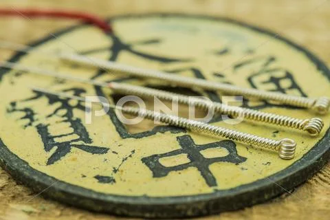 Acupuncture needles with antique chinese coin Stock Photos