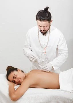 Acupuncturist asian race doing acupuncture in the spine of a beautiful woma.. Foto stock