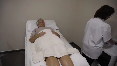 Acupuncturist inserts needles to a patient Video stock 99516017