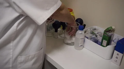 Acupuncturist prepares acupuncture session Stock Footage 99515995