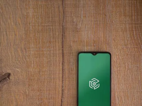 Adam Ai app launch screen on smartphone on wooden background Stock Photos
