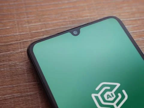 Adam Ai app launch screen on smartphone on wooden background Stock Photos