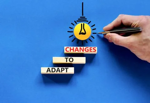 Adapt to changes symbol. Concept words Adapt to changes on wooden blocks. Bus Stock Photos
