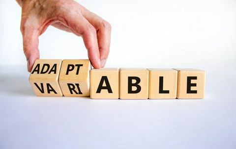 Adaptable or variable symbol. Businessman turns wooden cubes and changes the  스톡 사진