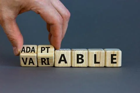 Adaptable or variable symbol. Businessman turns wooden cubes and changes the  Fotos de archivo