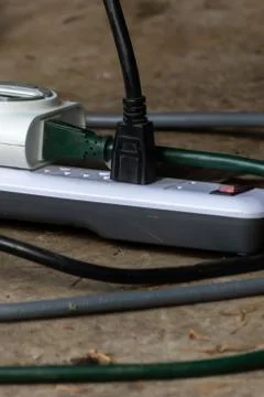 Adapter with multiple outlets and plugs sitting outside Stock Photos