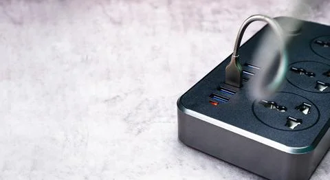 Adapter power plug with a USB port and multiple socket for mobile phone Stock Photos