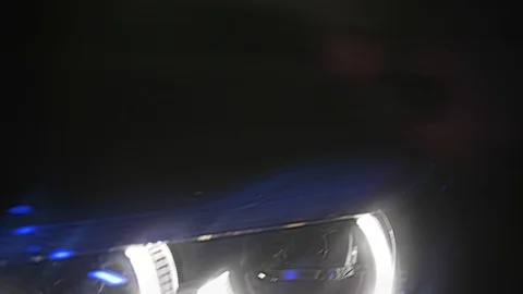 Adaptive LED optics for BMW 7 Series, close shot, color light and smoke Vídeos de archivo 125868101