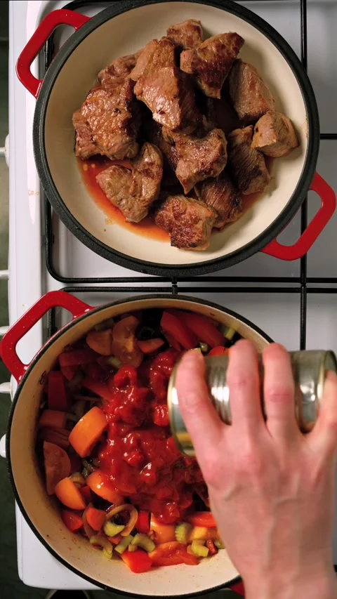 Add canned tomatoes to the pan with vegetables Stock Footage 330393430