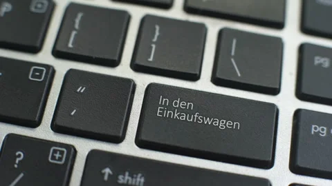 Add to cart in German button on computer keyboard female hand fingers press key Stock Footage 97828838