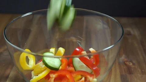 Add cucumber to salad. Vegetable salt for a healthy diet. Stock Footage 124076746