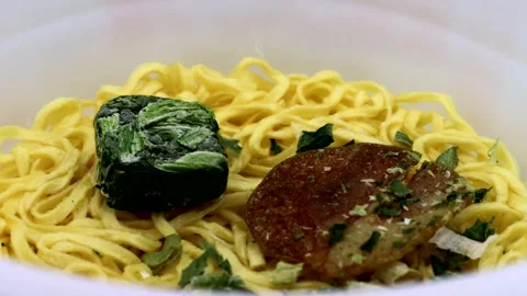 Add dried ingredients to instant ramen. Stock Footage 336341810