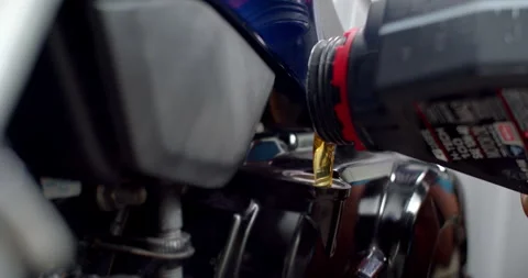 Add engine oil and check with a dipstick.Golden yellow oil is added to motor. Stock Footage 291686071