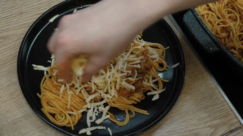 Add grated cheese to delicious spaghetti Stock Footage 311549155