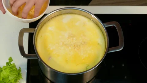 Add grated cheese to soup, stirring Video stock 78483653