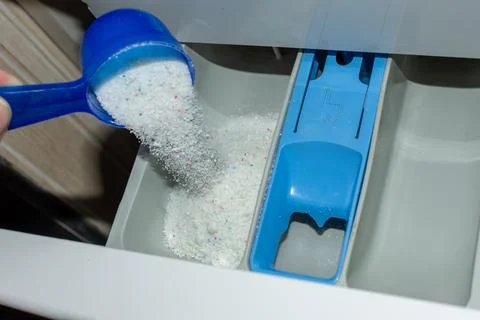Add the laundry detergent to the washing machine Stock Photos