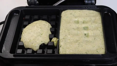 Add the liquid dough for waffles into, rectangular waffle iron. Stock Footage 294564501
