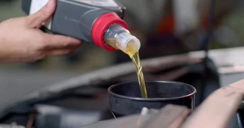 Add new engine oil to the engine. Extreme close up.Footage 60P Stock Footage 277843736