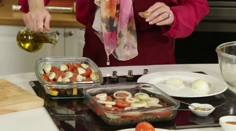 Add the olive oil in a container for roasting vegetables Stock Footage 49782308
