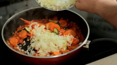 Add onion into frying pan Stock Footage 12760672