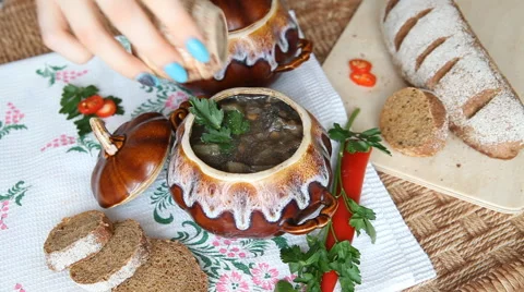 Add pepper to the soup in a pot on a Russian holiday table. Stock Footage 61875215